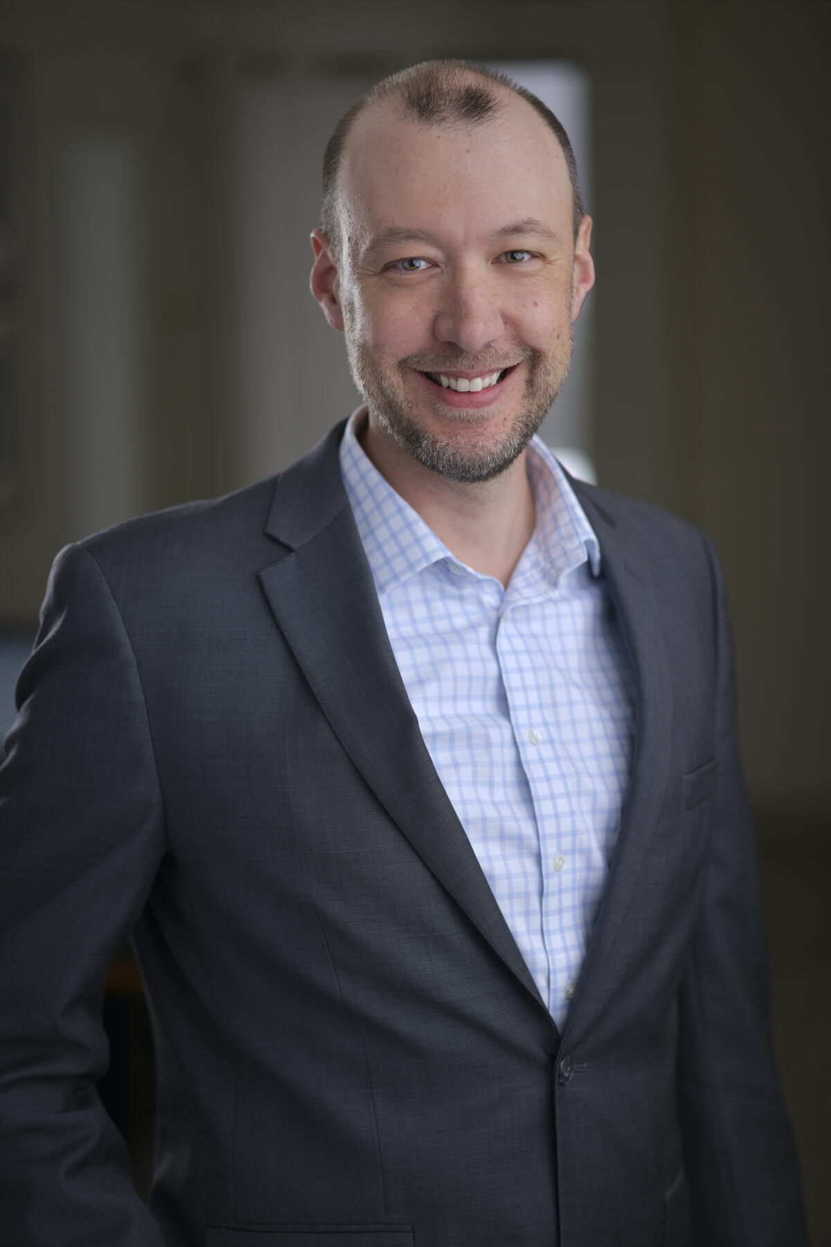 Simon Anderson professional portrait, gray suit smiling